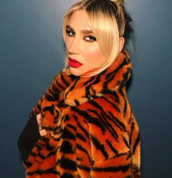 kesha posing with tiger printed jacket