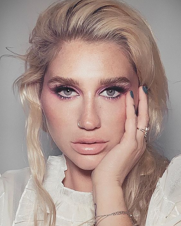 Kesha posing with her makeup on