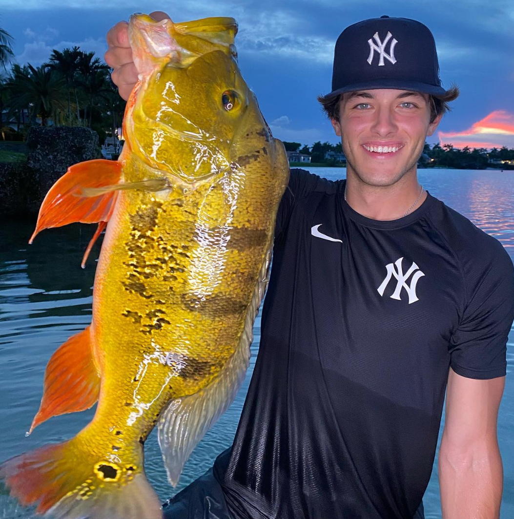 Griffin Johnson carrying a fish